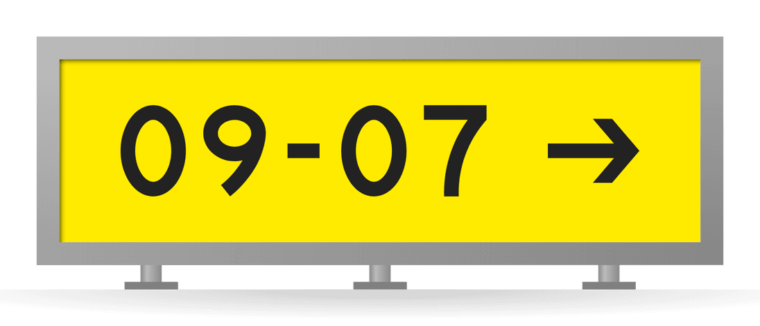 [09-07 →] Runway destination sign: the way to take-off runway 09-07, black on yellow in a gray-framed sign box